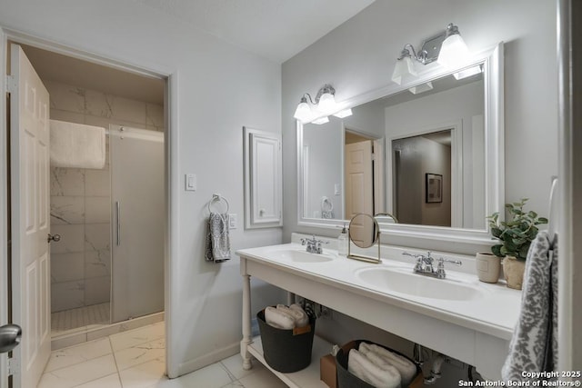 full bath with baseboards, a sink, marble finish floor, and a shower stall