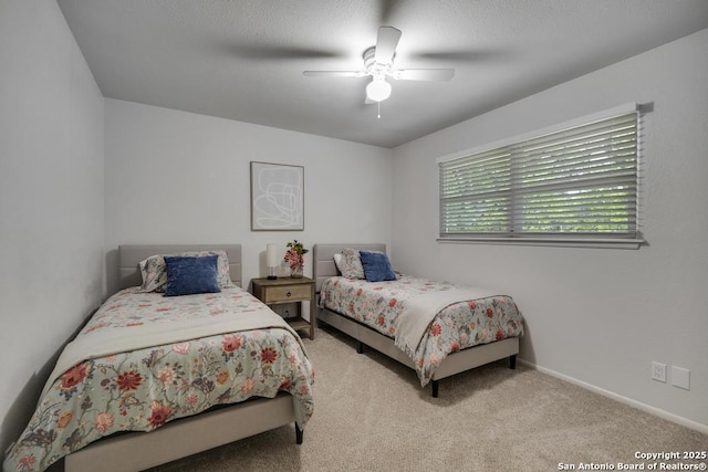 bedroom with baseboards, a ceiling fan, and carpet