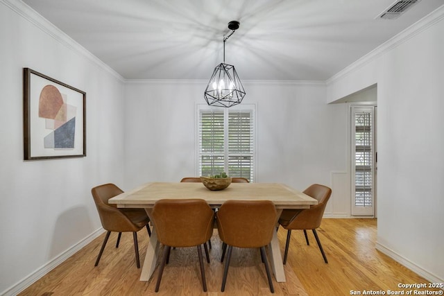 dining area featuring crown molding, visible vents, a wealth of natural light, and light wood-style floors