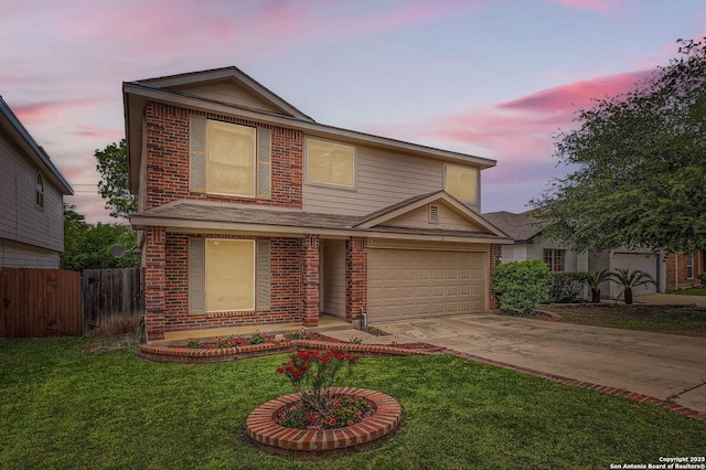 traditional home with brick siding, fence, a front yard, and concrete driveway