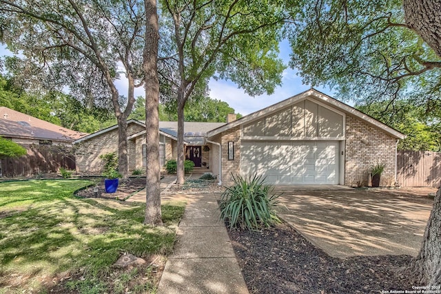 13402 Vista Del Mar, San Antonio, TX 78216 - mid-century modern home featuring brick siding, an attached garage, fence, and driveway