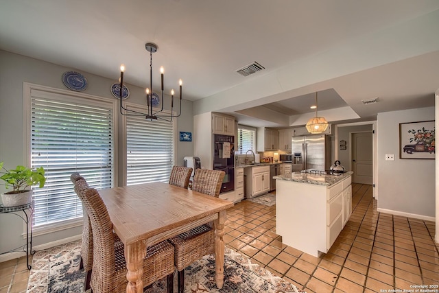 13402 Vista Del Mar, San Antonio, TX 78216 - dining room featuring visible vents, baseboards, a chandelier, a tray ceiling, and light tile patterned flooring