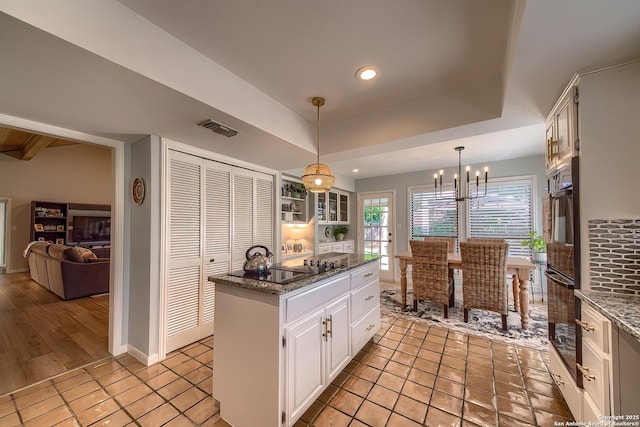 13402 Vista Del Mar, San Antonio, TX 78216 - kitchen featuring pendant lighting, glass insert cabinets, white cabinetry, dark stone countertops, and black appliances