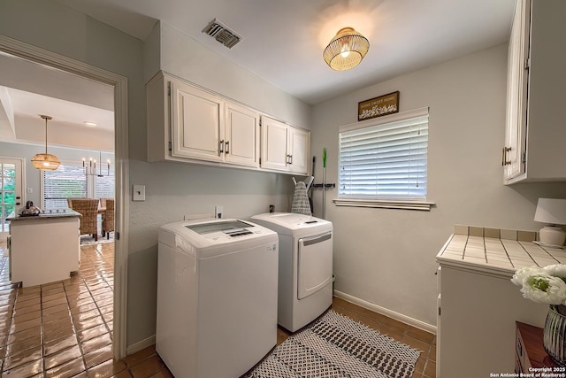 13402 Vista Del Mar, San Antonio, TX 78216 - laundry area featuring cabinet space, washer and dryer, tile patterned flooring, baseboards, and visible vents