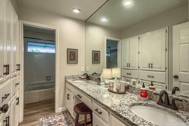 13402 Vista Del Mar, San Antonio, TX 78216 - full bath with double vanity, a sink, a bathtub, and wood finished floors