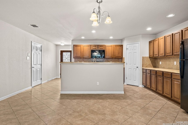 kitchen featuring recessed lighting, decorative backsplash, light tile patterned flooring, and black appliances