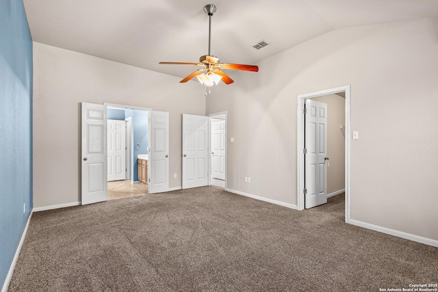 unfurnished bedroom with visible vents, baseboards, vaulted ceiling, and light colored carpet