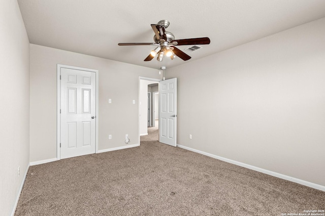 unfurnished bedroom with visible vents, a ceiling fan, baseboards, and carpet floors