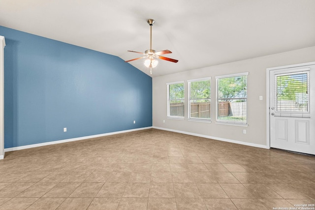unfurnished room featuring baseboards, a ceiling fan, and vaulted ceiling