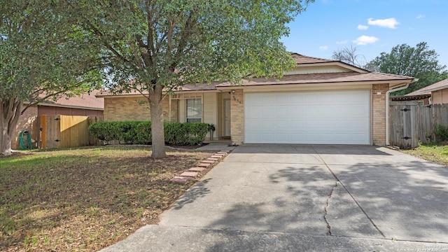 3634 Ridge Cluster, San Antonio, TX 78247 - view of front of home with fence, brick siding, a gate, an attached garage, and driveway