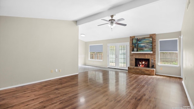 3634 Ridge Cluster, San Antonio, TX 78247 - unfurnished living room with ceiling fan, a brick fireplace, baseboards, vaulted ceiling with beams, and wood finished floors