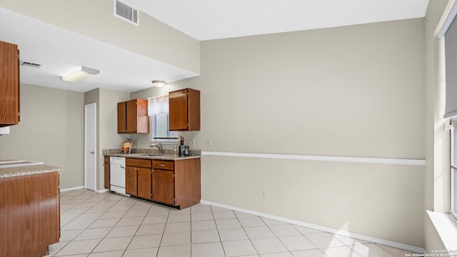 3634 Ridge Cluster, San Antonio, TX 78247 - kitchen with white dishwasher, baseboards, brown cabinets, and visible vents