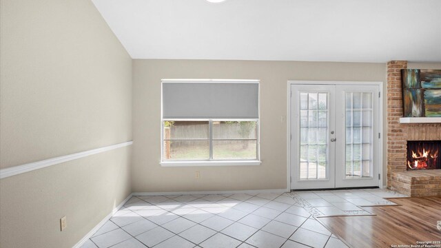 3634 Ridge Cluster, San Antonio, TX 78247 - doorway with tile patterned floors, baseboards, french doors, and a brick fireplace