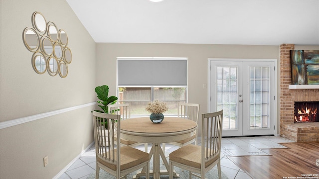 3634 Ridge Cluster, San Antonio, TX 78247 - dining room featuring baseboards, french doors, tile patterned flooring, and a fireplace