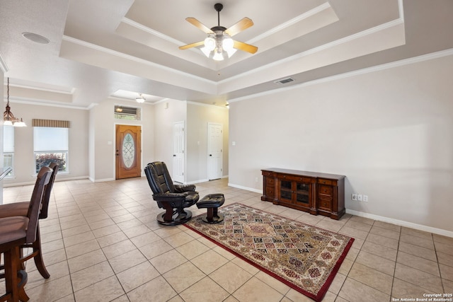 living room with light tile patterned floors, a raised ceiling, ceiling fan, and visible vents