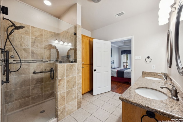 full bathroom with visible vents, a sink, ensuite bathroom, and a shower stall