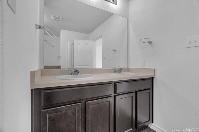 full bathroom with double vanity, a sink, and visible vents