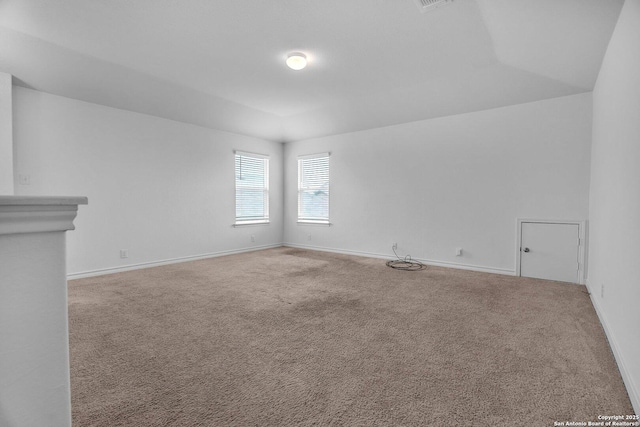 carpeted spare room featuring baseboards