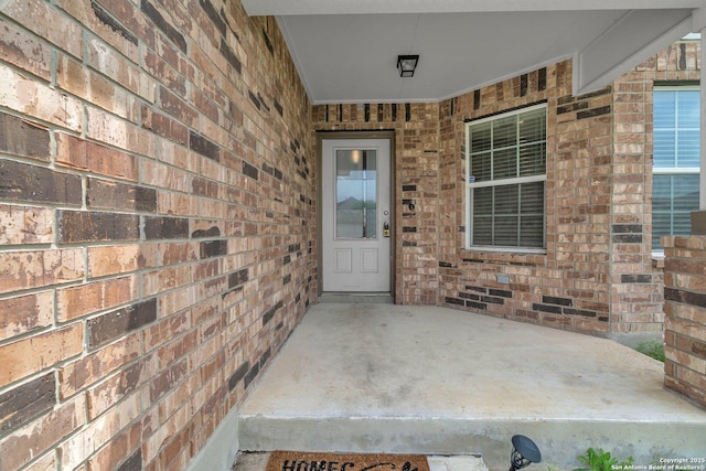 entrance to property with brick siding