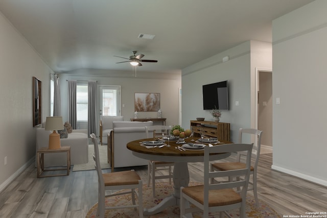 dining room featuring a ceiling fan, baseboards, visible vents, and light wood-type flooring