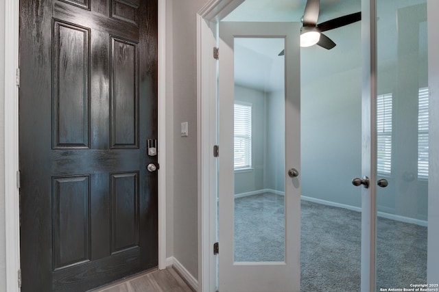 carpeted entryway with baseboards, ceiling fan, and french doors
