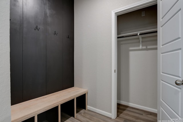 interior space with baseboards and wood finished floors