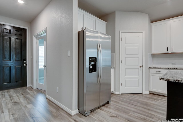 kitchen featuring light wood finished floors, white cabinets, and stainless steel fridge with ice dispenser