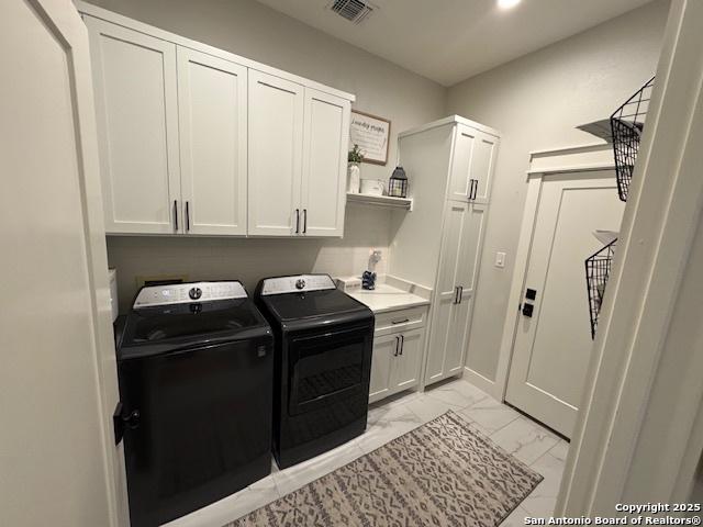 laundry room featuring visible vents, washing machine and dryer, cabinet space, marble finish floor, and recessed lighting