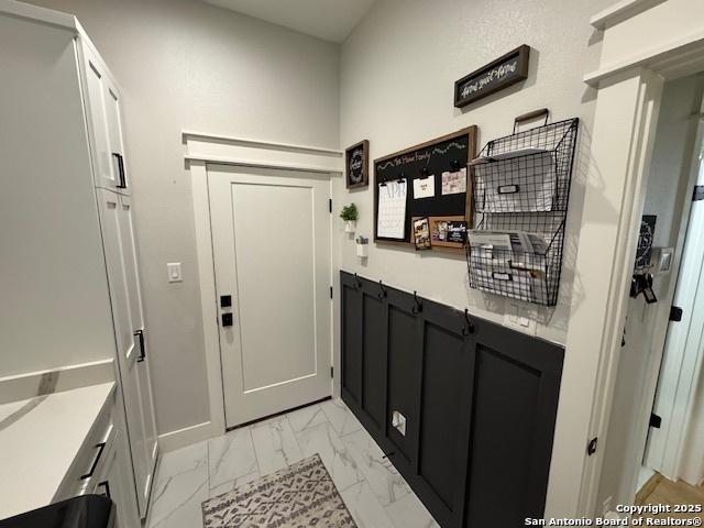 doorway featuring marble finish floor