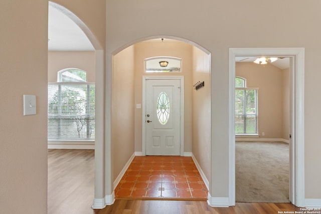 29303 Sumpter Dr, Boerne, TX 78015 - foyer entrance featuring baseboards, arched walkways, and wood finished floors