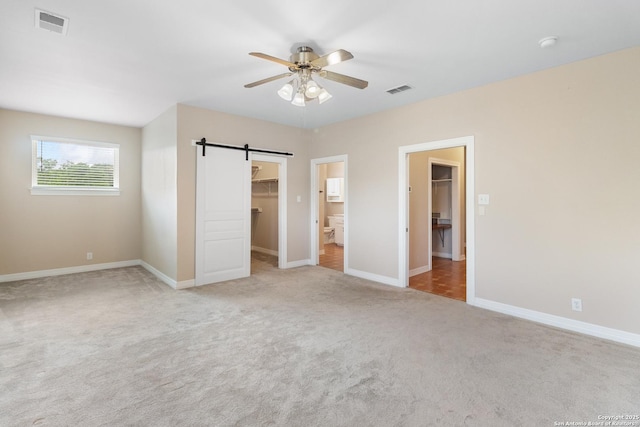 29303 Sumpter Dr, Boerne, TX 78015 - unfurnished bedroom featuring carpet flooring, baseboards, visible vents, and a walk in closet