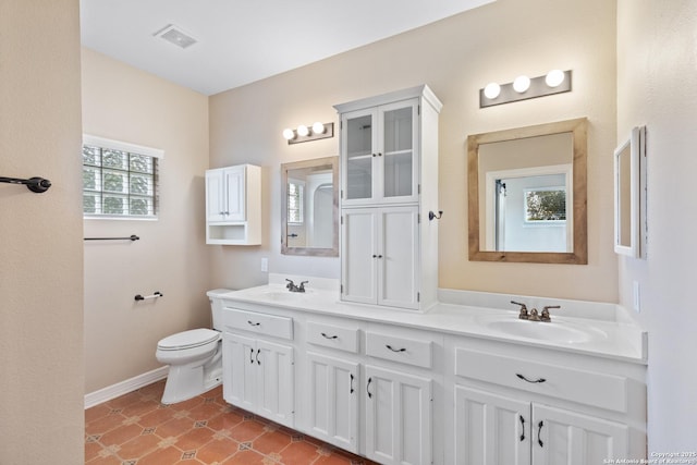 29303 Sumpter Dr, Boerne, TX 78015 - bathroom featuring visible vents, a sink, double vanity, and toilet