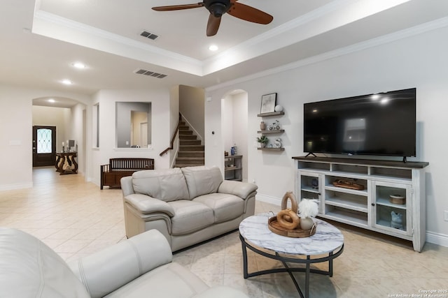 living area with visible vents, arched walkways, and a ceiling fan