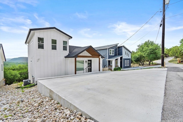 modern farmhouse with board and batten siding and cooling unit