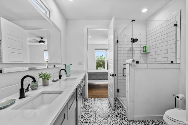 bathroom featuring recessed lighting, a sink, toilet, and a shower stall