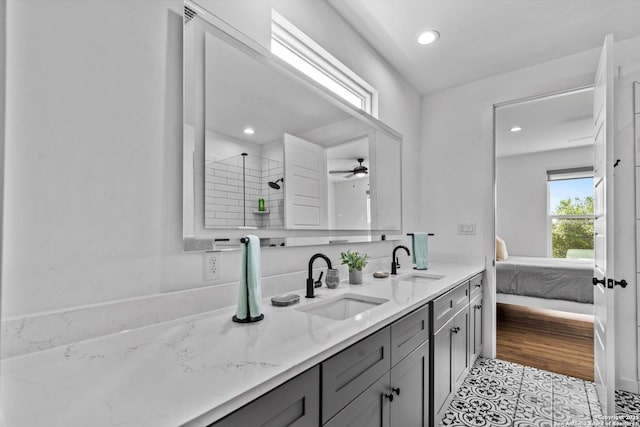 full bath featuring a sink, recessed lighting, double vanity, and connected bathroom