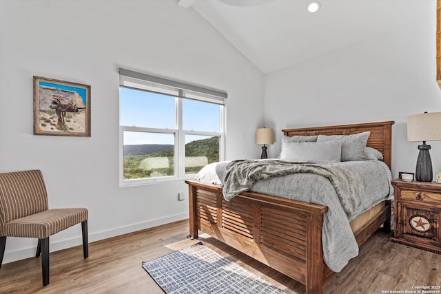 bedroom with recessed lighting, baseboards, high vaulted ceiling, and wood finished floors