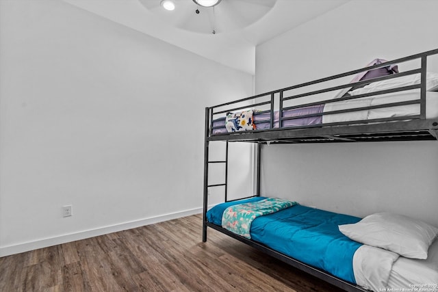 bedroom with baseboards, ceiling fan, and wood finished floors