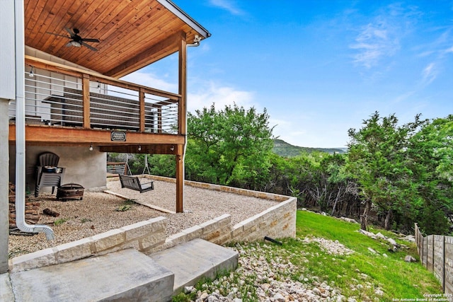 view of yard featuring a ceiling fan and a wooden deck