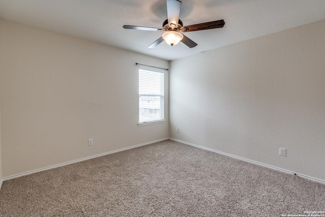 empty room with carpet floors, ceiling fan, and baseboards