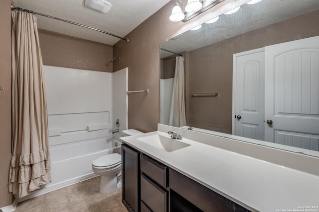 full bath with shower / bath combo with shower curtain, vanity, a textured wall, toilet, and tile patterned floors