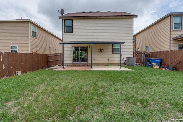 rear view of property with a lawn, a fenced backyard, and a patio area