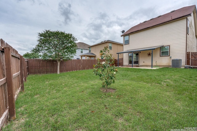 view of yard with a fenced backyard, a patio area, and central AC unit