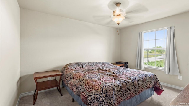 bedroom with carpet floors, baseboards, and a ceiling fan