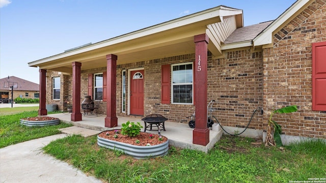 view of front of property featuring covered porch and brick siding