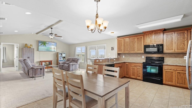 kitchen featuring decorative backsplash, a peninsula, open floor plan, light tile patterned floors, and black appliances