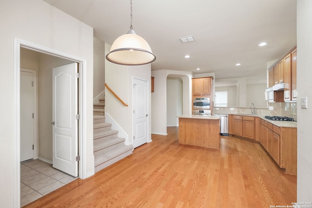 5803 Sugarberry, San Antonio, TX 78253 - kitchen featuring visible vents, a kitchen island, light countertops, a sink, and stainless steel appliances