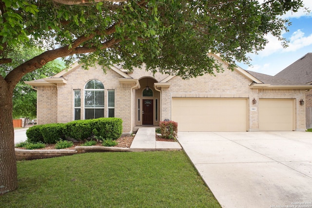 5803 Sugarberry, San Antonio, TX 78253 - view of front of property with a front yard, brick siding, a shingled roof, an attached garage, and driveway