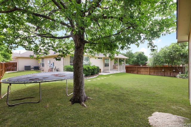 5803 Sugarberry, San Antonio, TX 78253 - view of yard featuring central air condition unit, a trampoline, fence, and a patio
