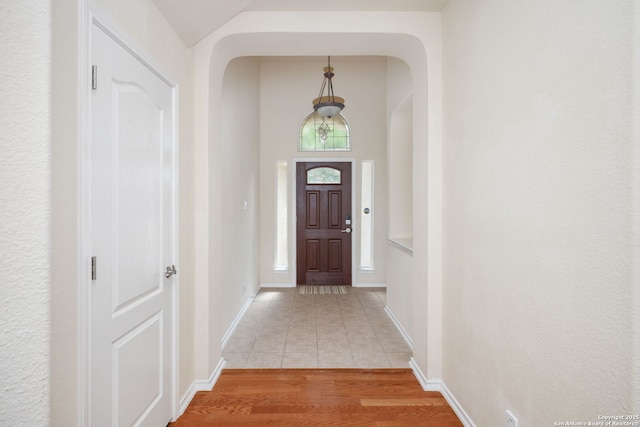 5803 Sugarberry, San Antonio, TX 78253 - doorway to outside with light tile patterned floors, arched walkways, and baseboards